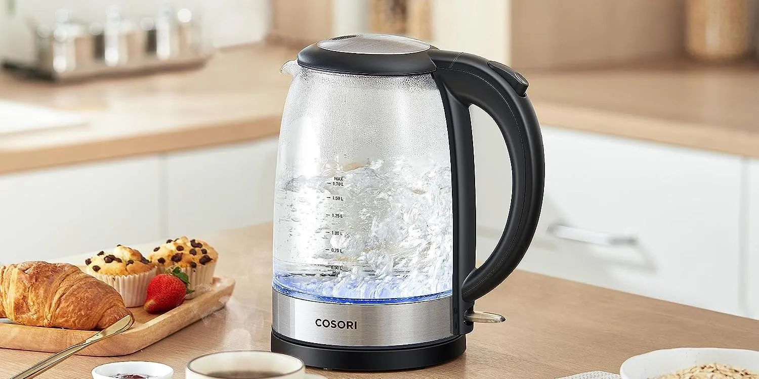 Person pouring water from a variable temperature kettle into a teacup